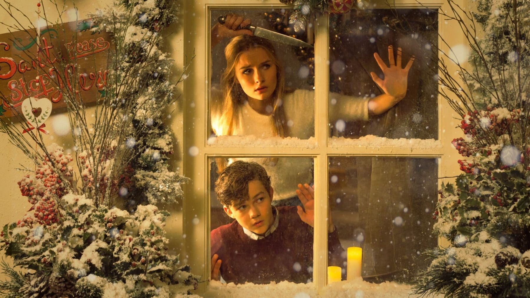 better watch out movie a woman and a man look out a window with a Christmas tree on the left hand side
