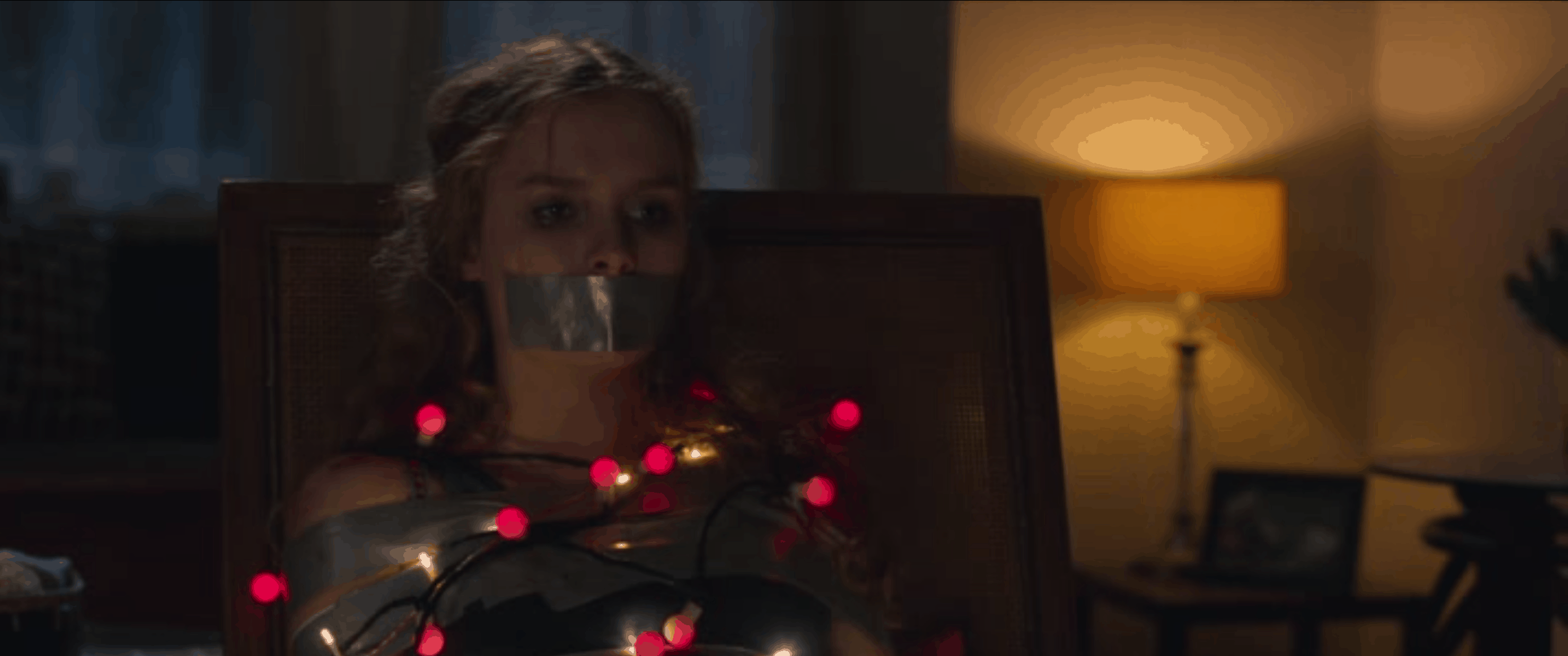better watch out movie a woman is tied up with a string of Christmas lights with her mouth duct taped